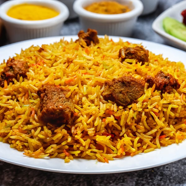 Close-up of a plate of Biryani Pot's Indian biryani, featuring spiced rice and tender meat.